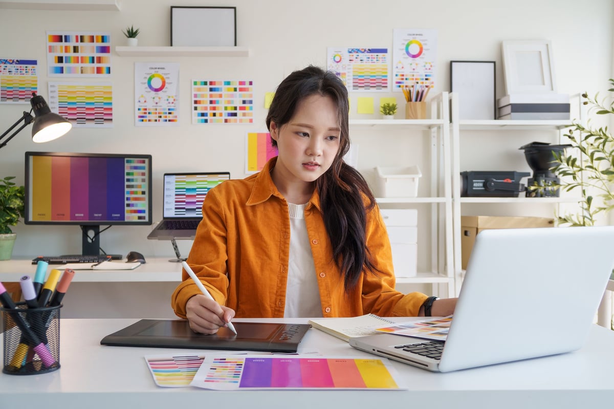 Creative young woman concentrating on design projects at her workspace